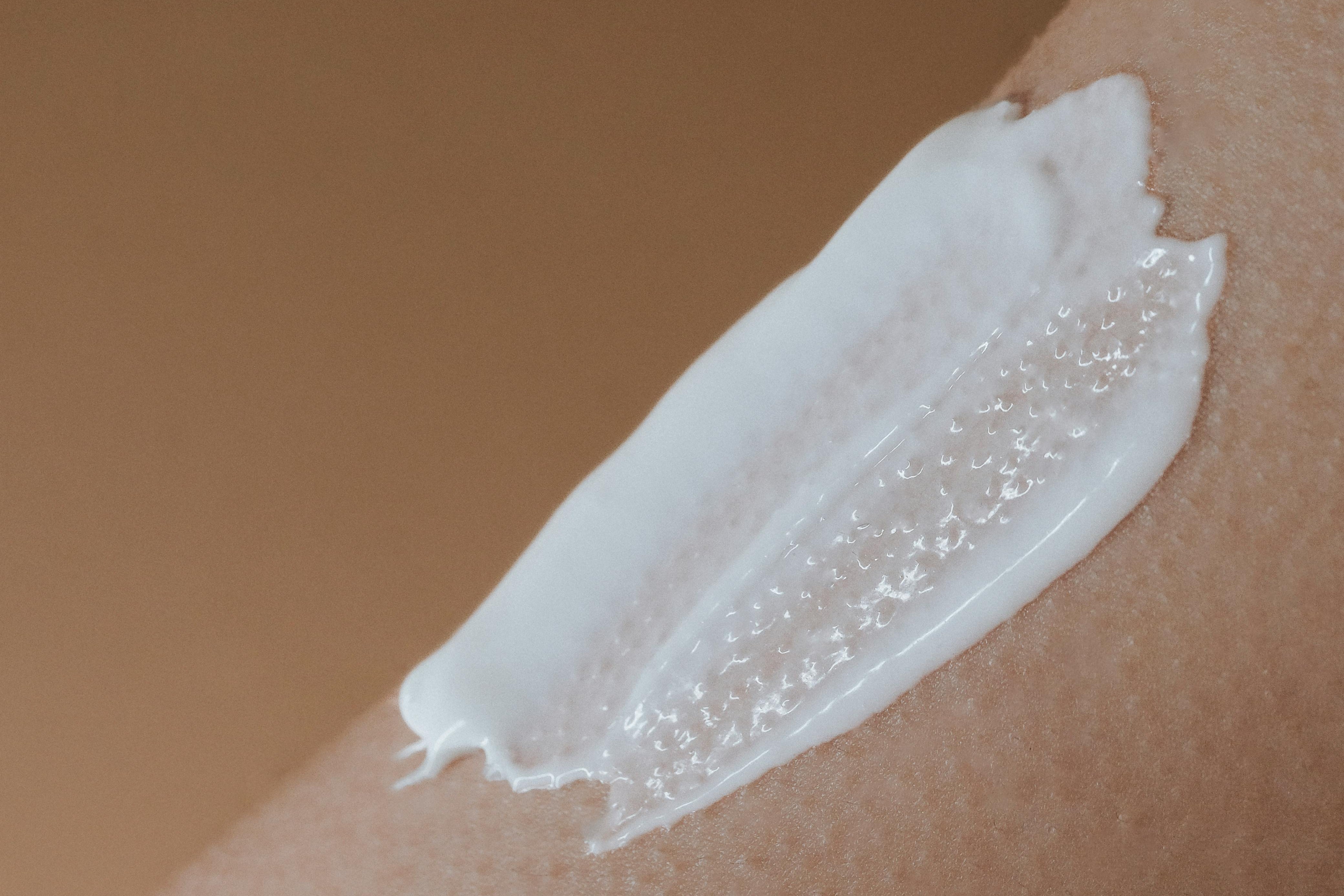 A layer of skincare cream spread over skin as part of a skincare routine